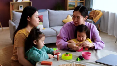 Mothers and babies in living room