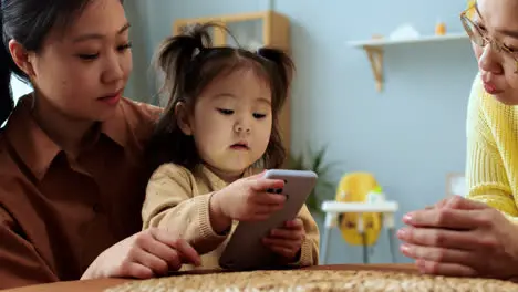 Asian women with a baby sitting at a table