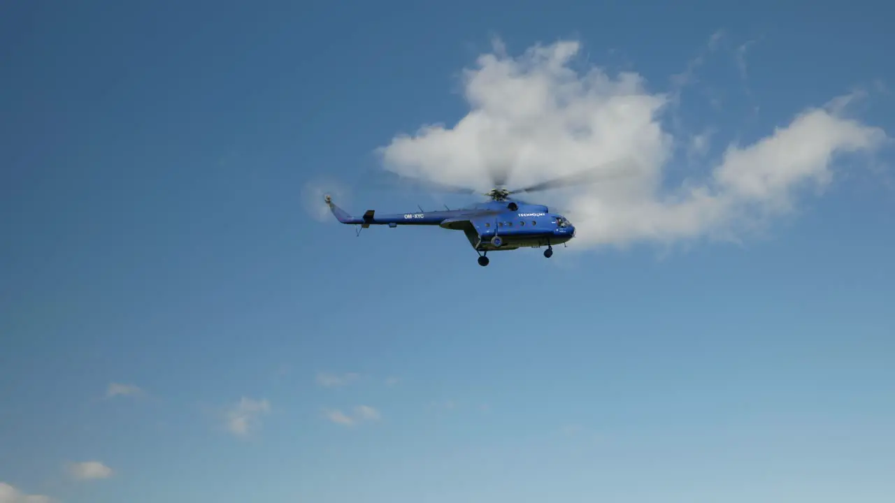 Civilian Mi 8 helicopter descending for landing approaching airfield in mountains