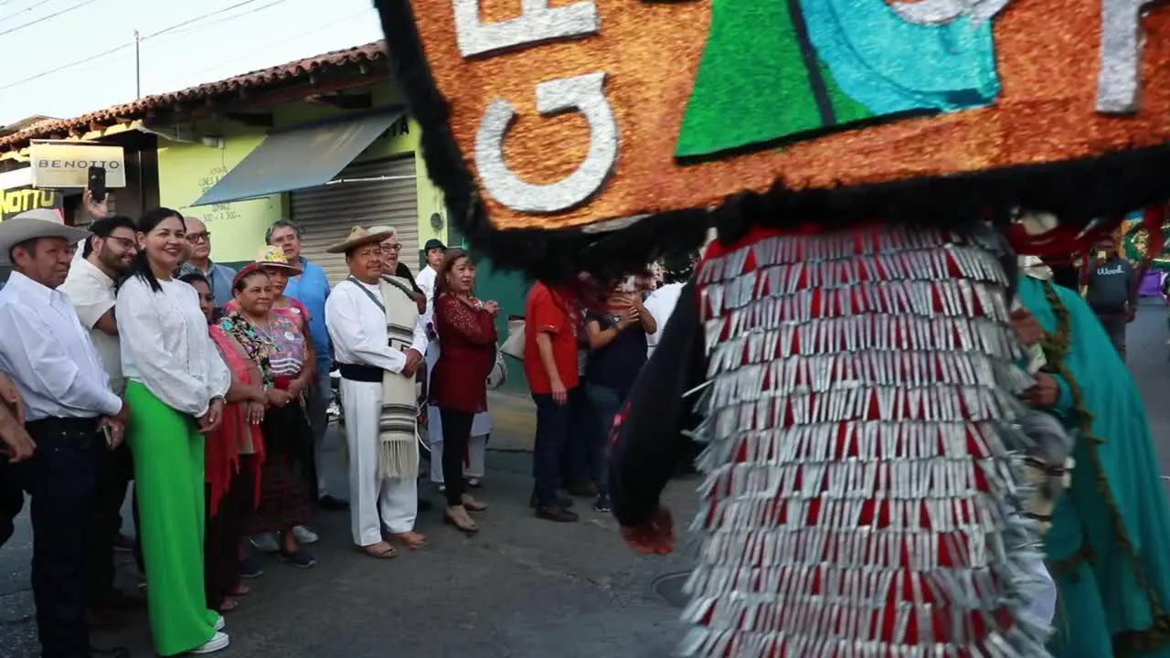 People Watching The Two Men In Traditional Costume And Mask Re-enact The Sword Fight During Ancestral Dance Event In Tuxpan Jalisco Mexico