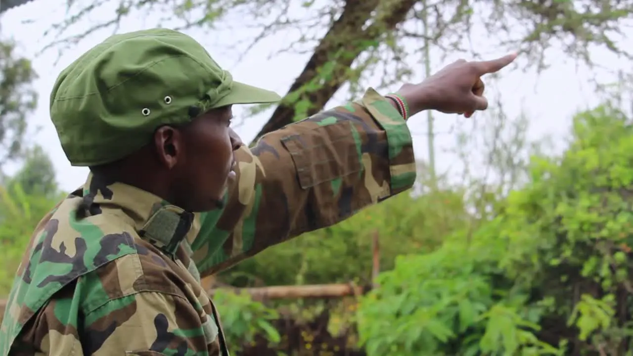 Officer showing signs to soldiers in forest on a overcast day in Africa