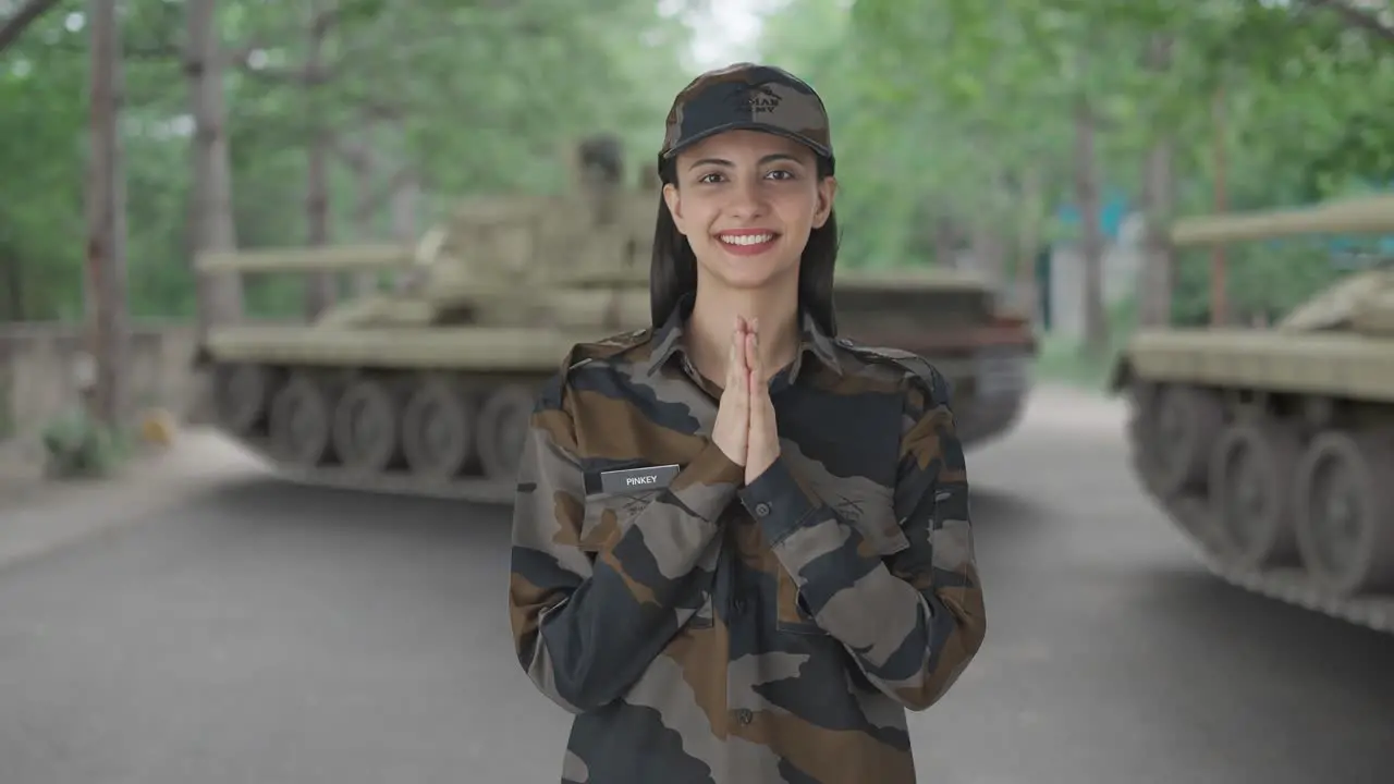 Happy Indian woman army officer doing Namaste