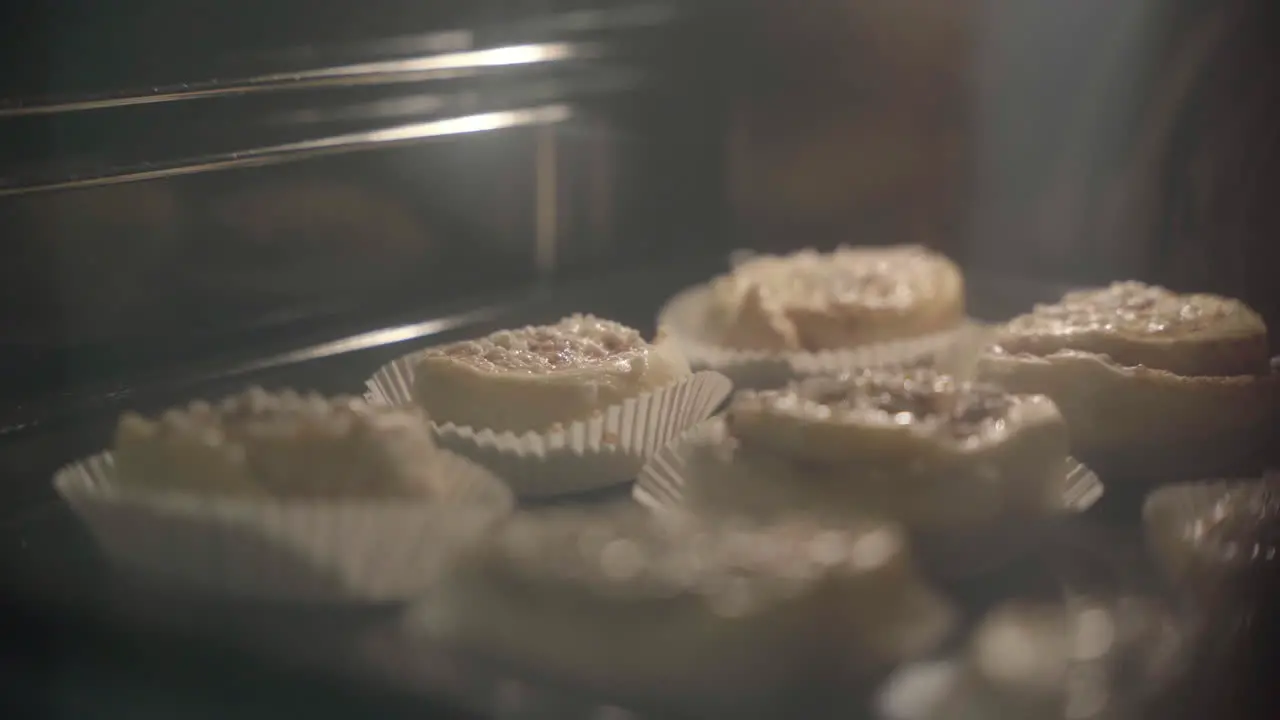 Medium shot of cinnamon buns getting baked in the oven