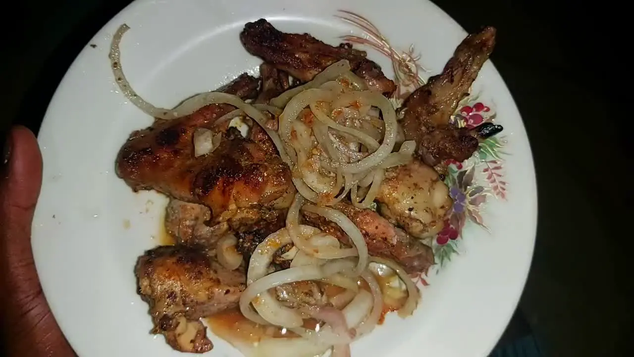 Chicken Yassa Gambian spicy barbecued Chicken Yassa plate with lemon and onions