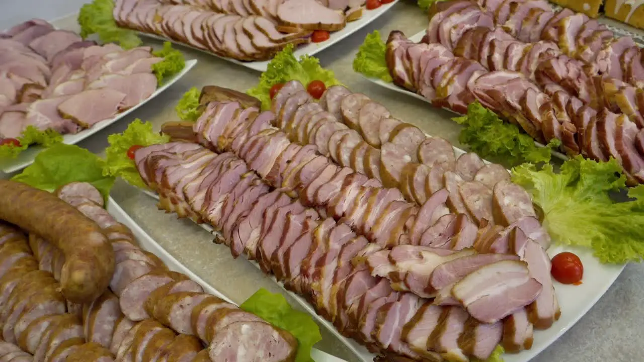 Platter with slices of ham bacon and sausage