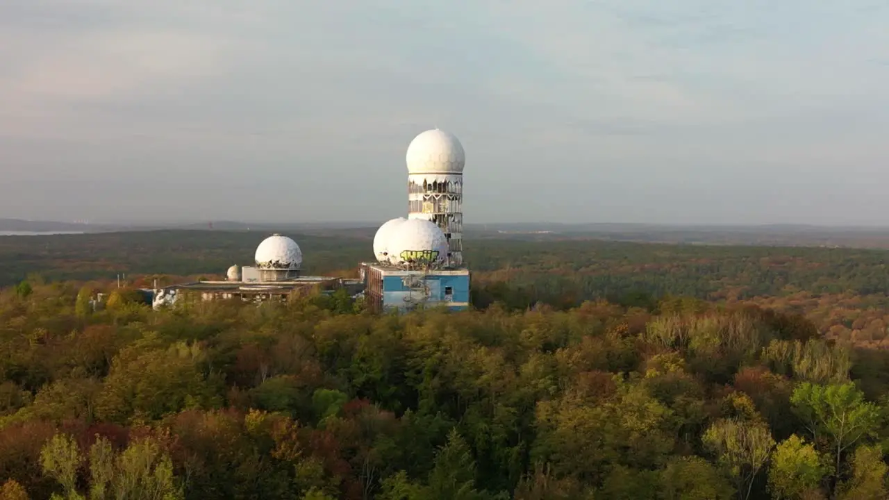 Spectacular aerial view flight wide orbit cinematic drone of Radoms in
autumn forest at morning sunrise devil's mountain in woods berlin October 2022