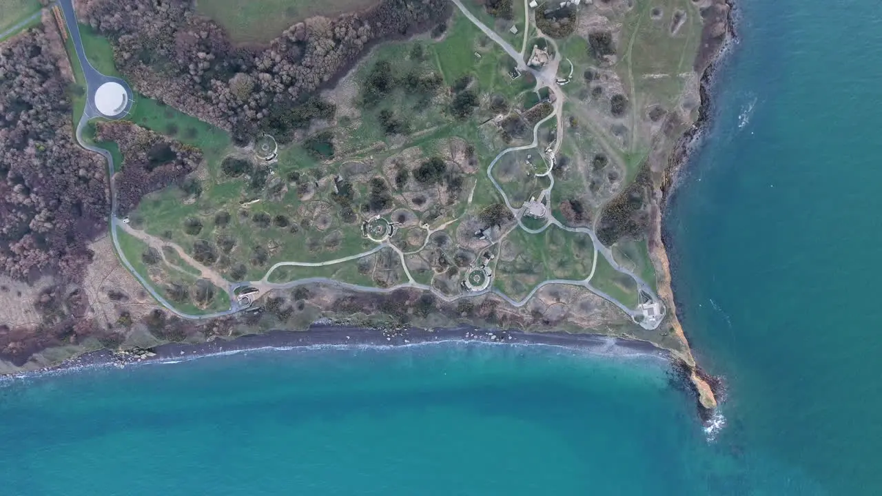 Vertical drone view over la Pointe du Hoc shell holes craters German concrete