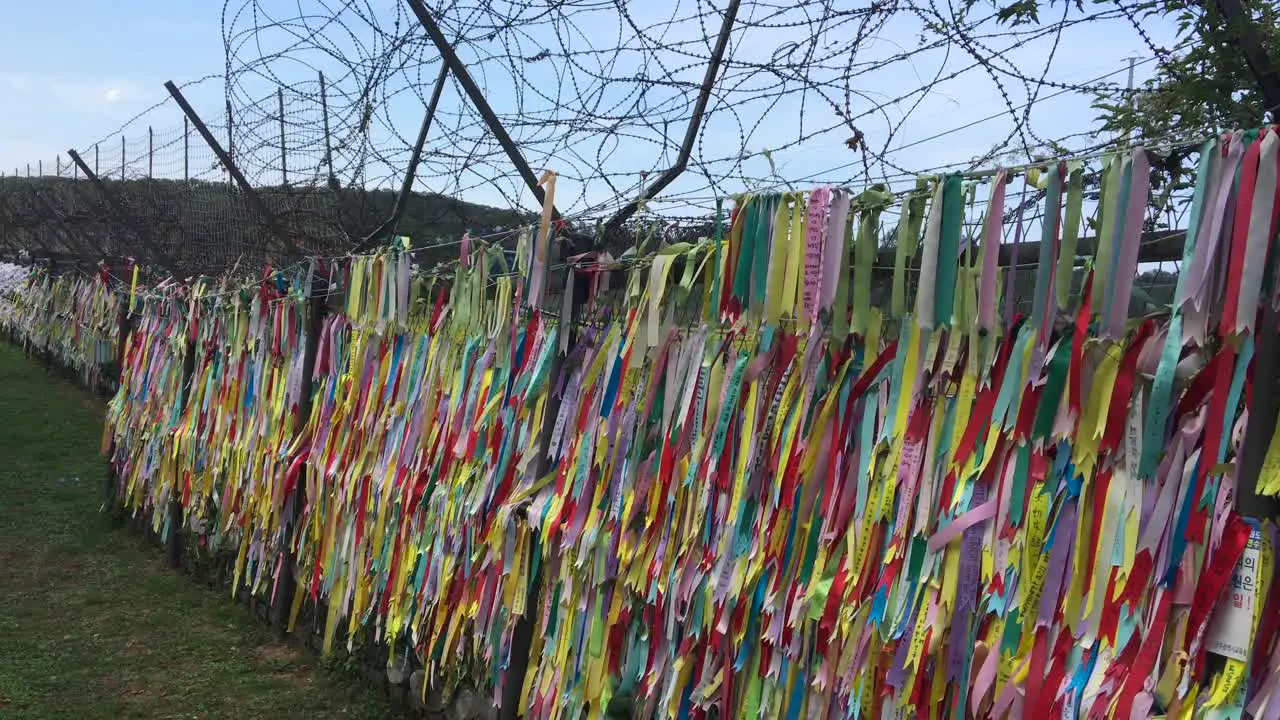 Ribbons of hopes hang at barbed wire fence at Imjingak by the DMZ overlooking North Korea in Munsan Paju Gyeonggi-do South Korea