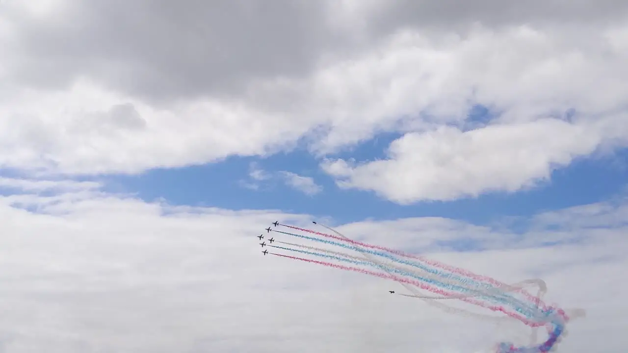 Red Arrows Planes Flying in Formation with 2 Planes Barreling Around on Outside During Air Show in Swansea