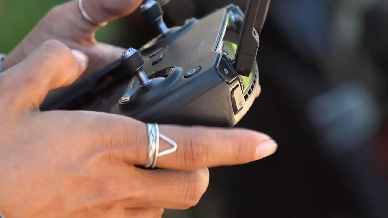 Close Shot of a Woman Using a Drone Controller