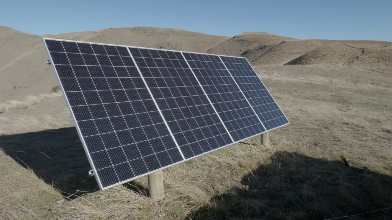 Steady shot of single solar panel in mountainous highlands