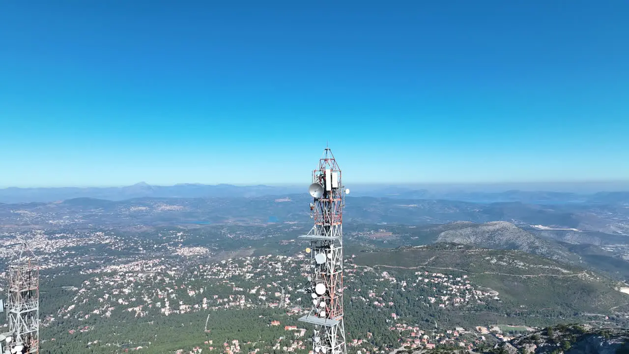 Flying away from a telecommunication tower on top of a mountain