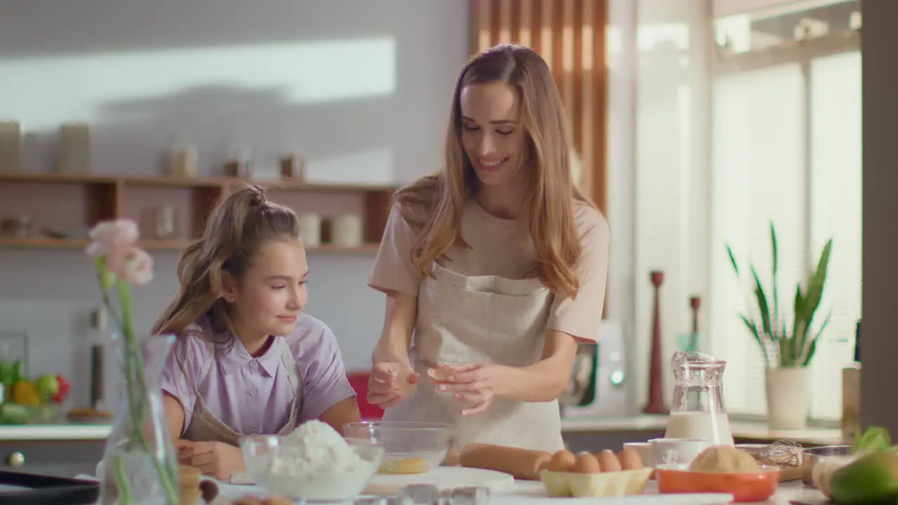 Mother and daughter baking together at home