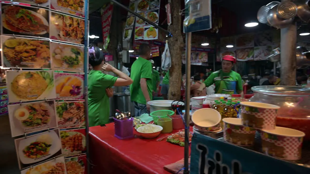 Cooking and selling food at Chatuchak Weekend Night Market hawkers offer a wide variety of choices ranging from spicy fried squid chicken hotdogs and many more located in Bangkok Thailand