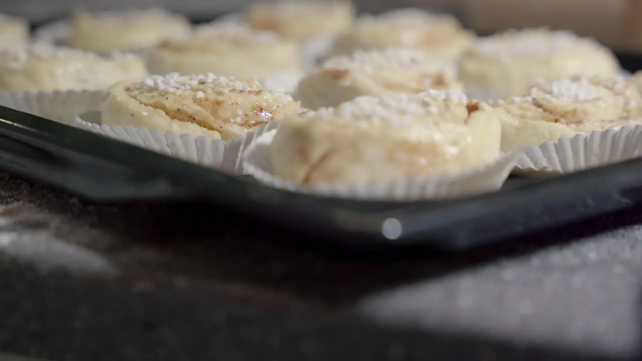 Close up slide of unbaked cinnamon buns on a tray