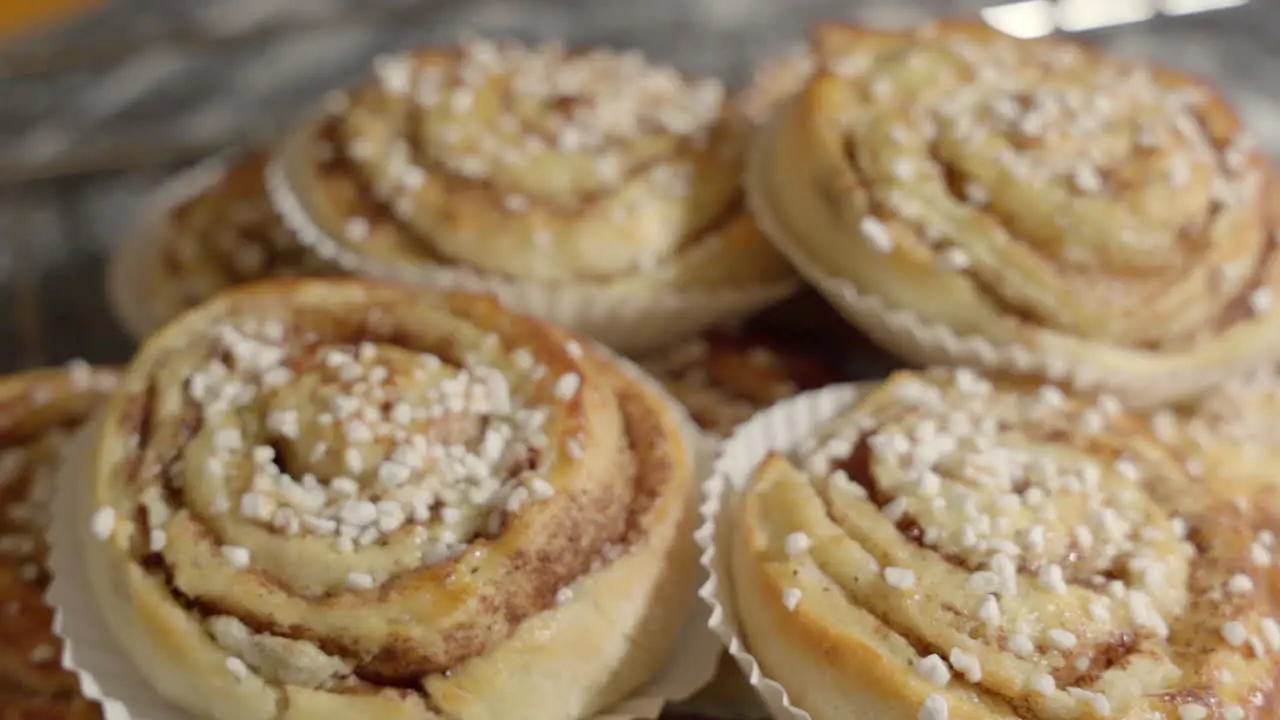 Medium handheld shots footage of a pile of cinnamon buns