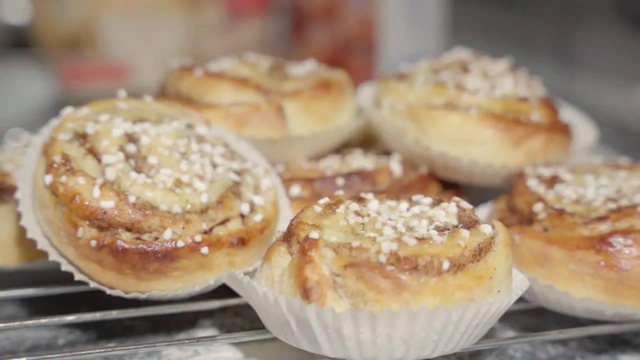 Male hand picking up a cinnamon bun