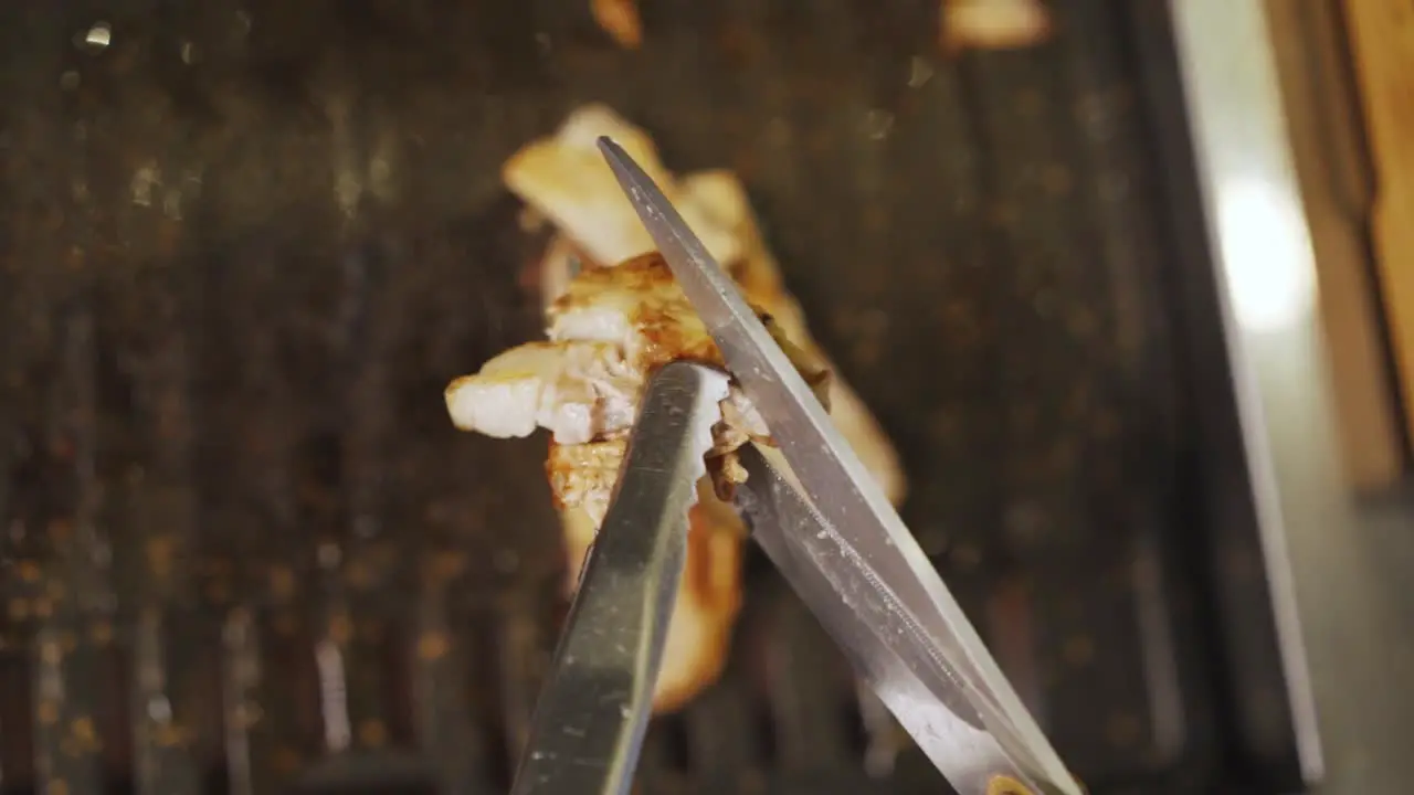 Samgyeopsal Person Cutting Grilled Pork Belly With Scissors