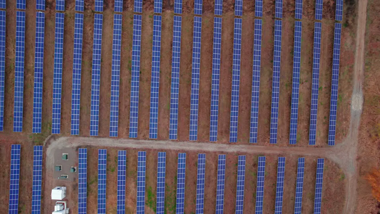 Birds eye view of top down of solar panels installed in a pattern grid