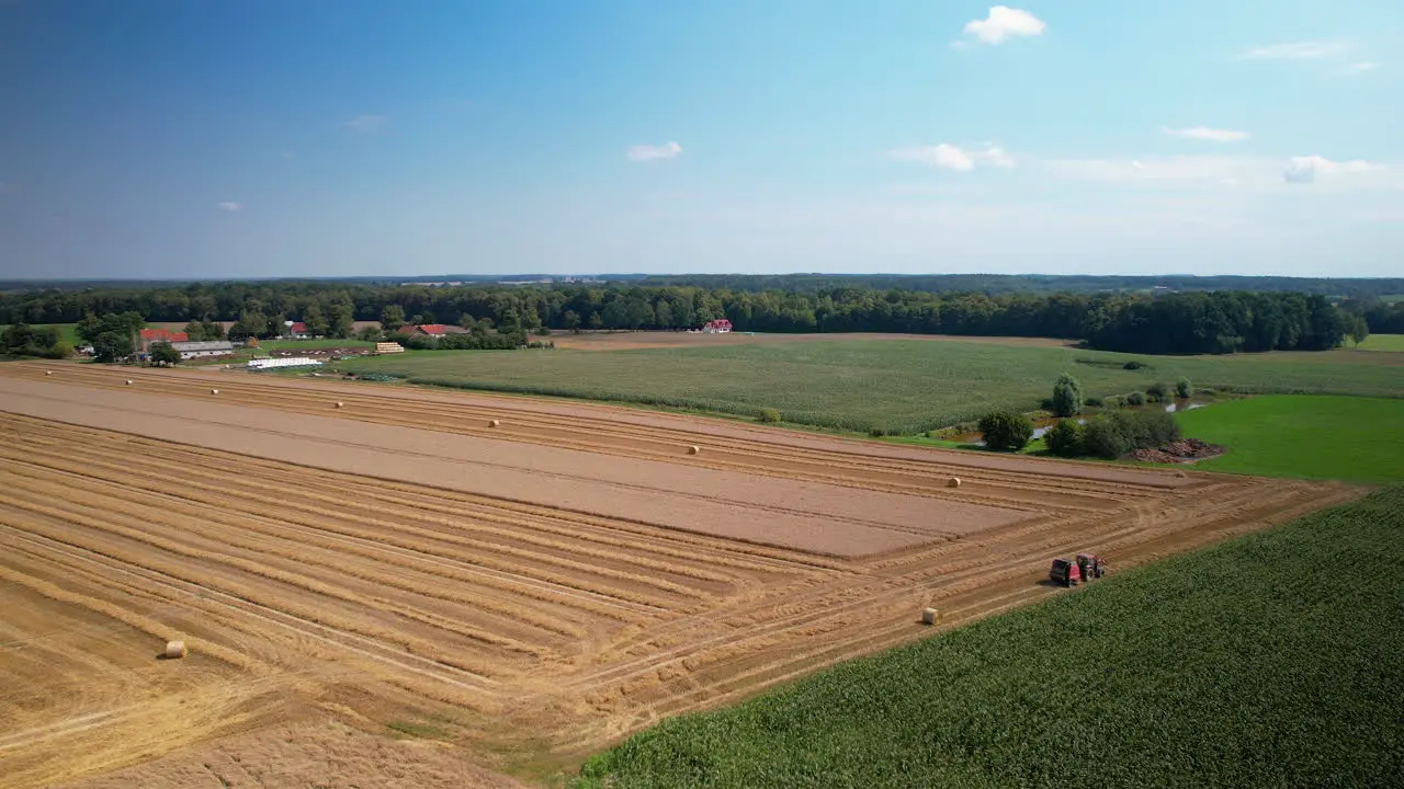 Aerial view of tractor toiling for harvest in agriculture farm land