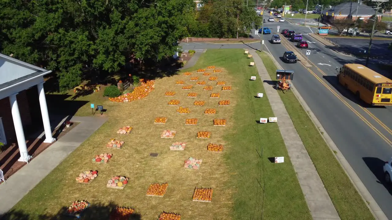 Forward aerial shot of church pumpkin patch in