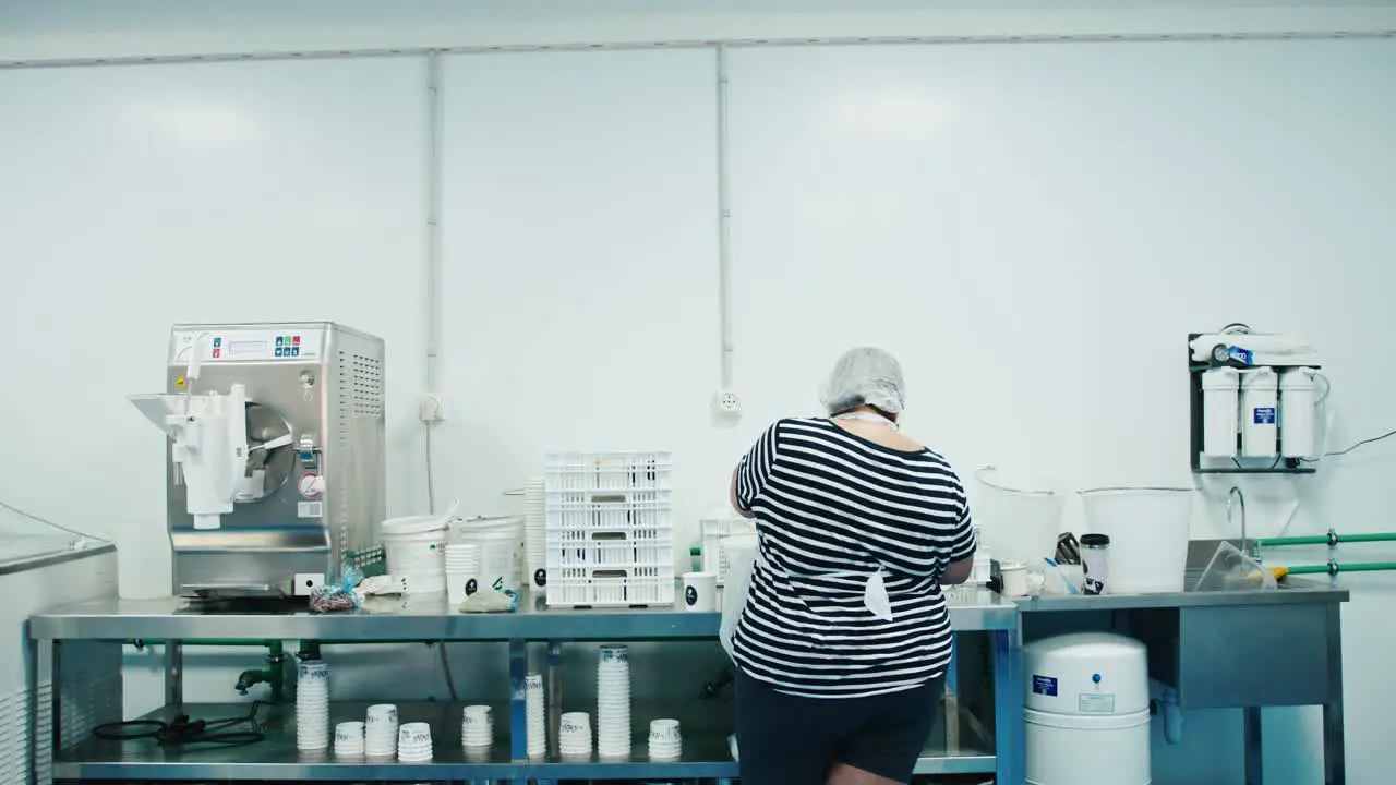 Lady working and sorting food for a family owned business in a factory