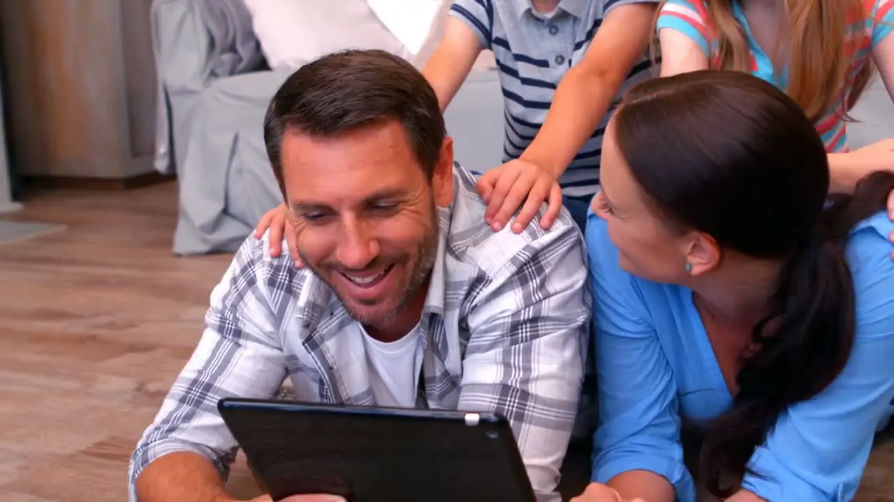 Family using tablet in living room