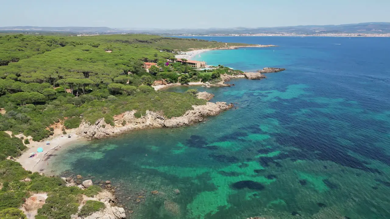 Small coves and luxury hotel resort at Cala Spinosa Beach Sardinia Italy 4k Aerial