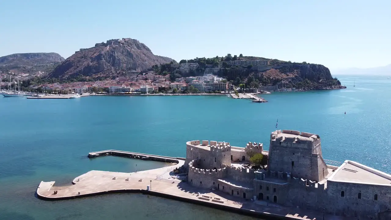 Bourtzi Fortress and Nafplio Cityscape in Peloponnese Greece Aerial Forward