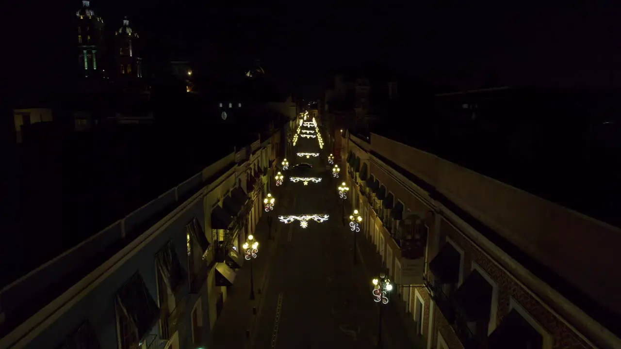 Drone footage of the Christmas light decorations in the streets of Puebla México with the Cathedral in the background