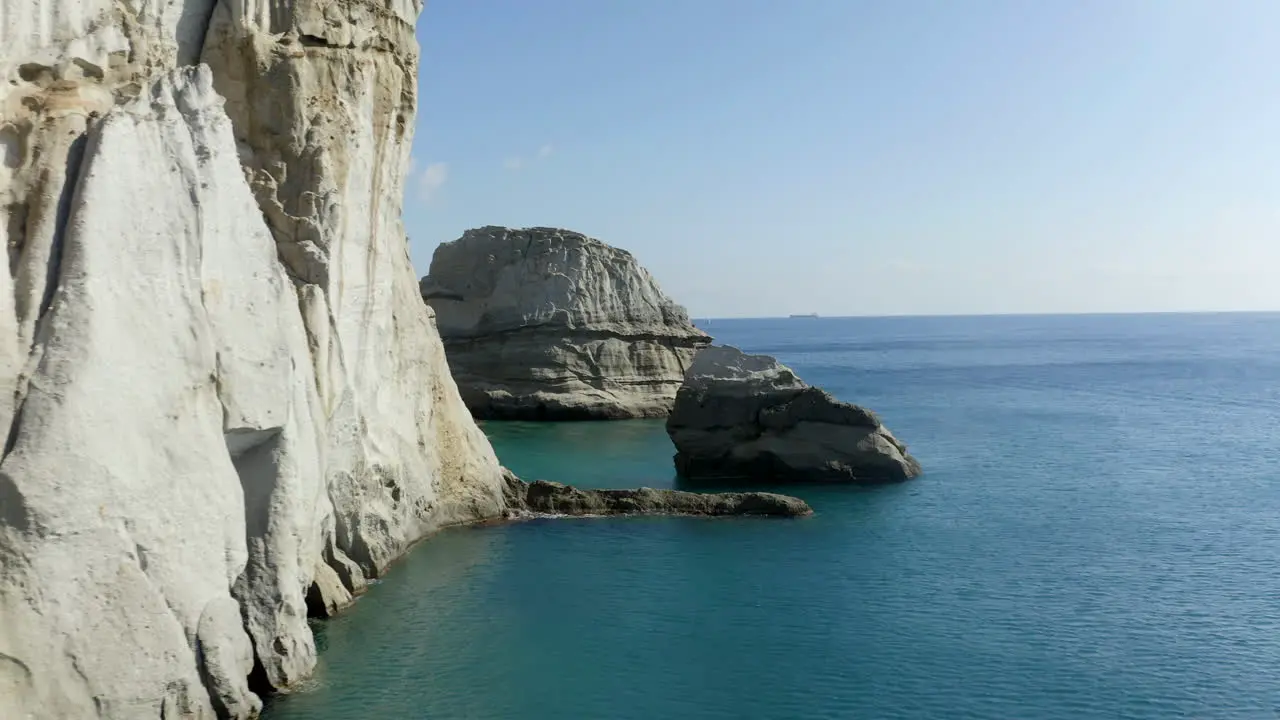 Klefitko white cliffs drone shot over the blue waters and dramatic coastline of the greek island of Milos Greece in 4k