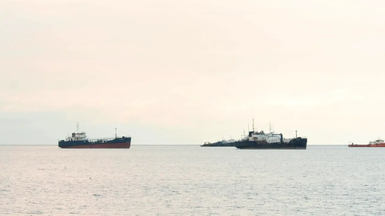 Naval maritime ships anchored in shallow oceanic territorial waters at the coast of Panama Citys's Causeway of Amador during a cloudy summer day