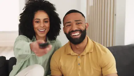 Happy black couple relax and watching tv on sofa