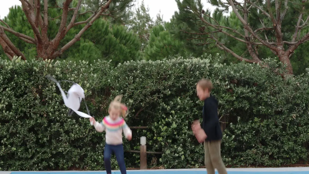 Kids enjoying trampoline jumping on the outdoor playground