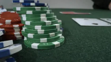 Sliding Extreme Close Up Shot of Poker Player Looking at Pocket Tens Before Shoving