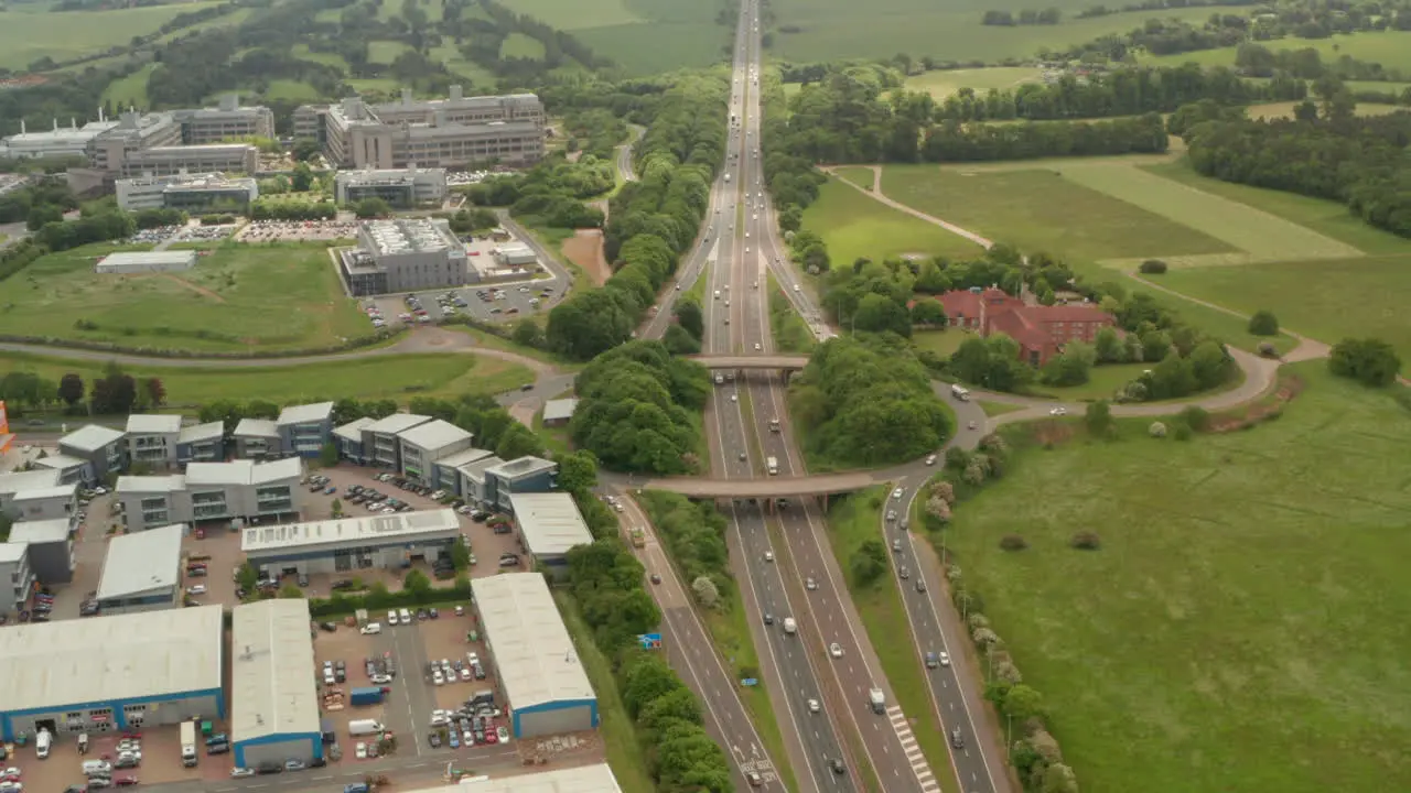 Establishing aerial shot of raised road interchange over A1 motorway UK