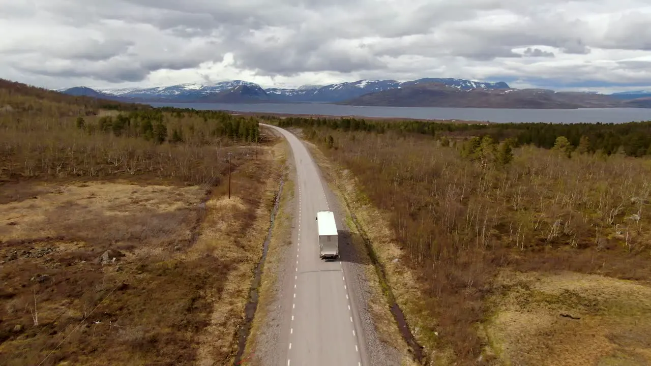 Drone footage follows a truck in autumn in north of Sweden