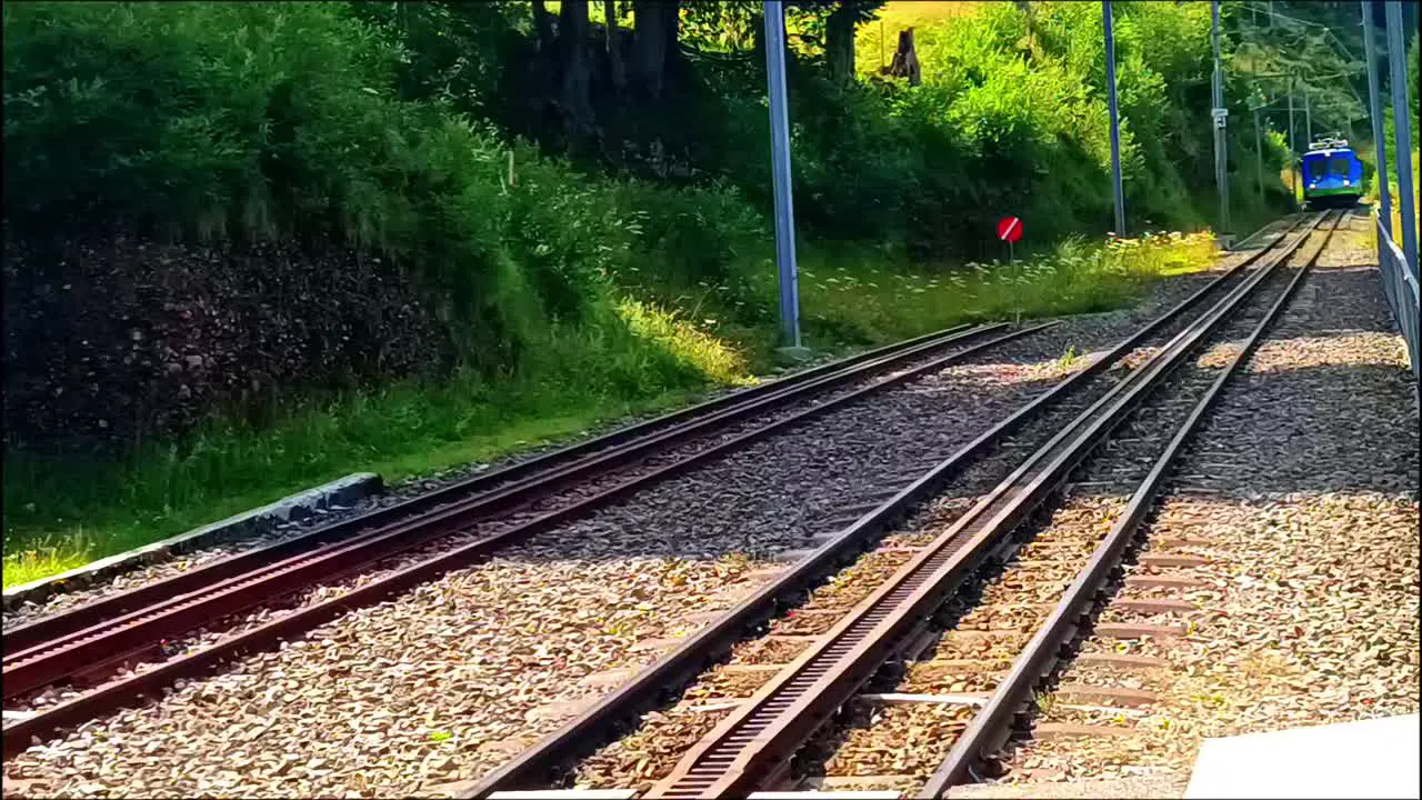 Blue train is arriving on the mountain path