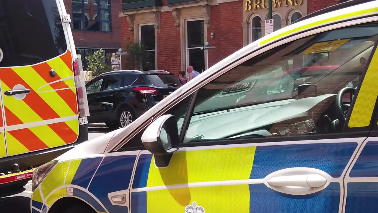 Slow motion pan of parked Nottingham Metropolitan police cars