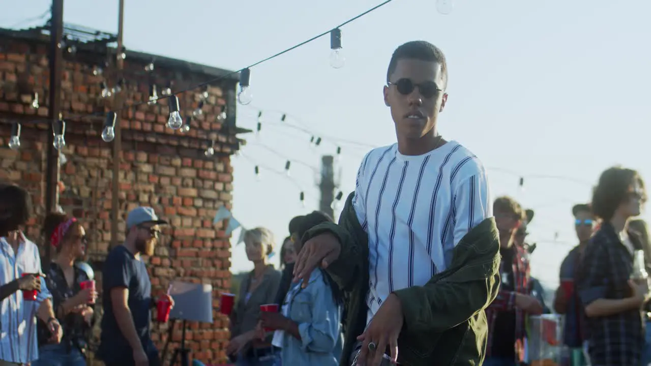 Young Stylish Guy In Black Sunglasses Dancing Cheerfully In Front Of The Camera At The Rooftop Party At Daytime 3