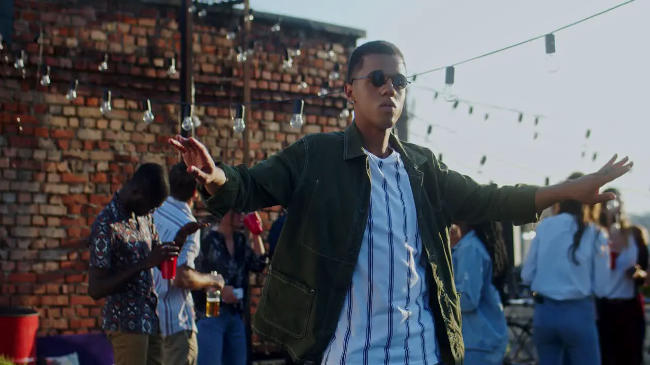 Young Stylish Guy In Black Sunglasses Dancing Cheerfully In Front Of The Camera At The Rooftop Party At Daytime 1