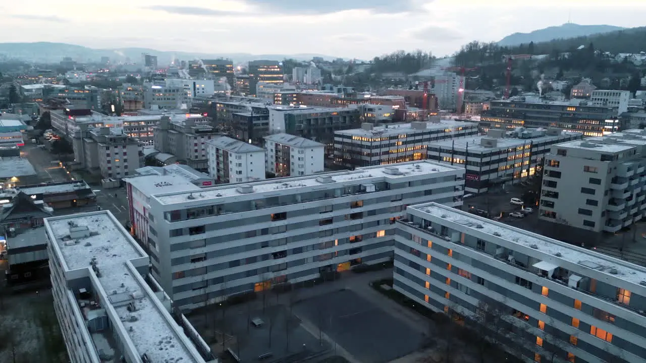 straight forward flight over an urban area with the bright building indoor lights on