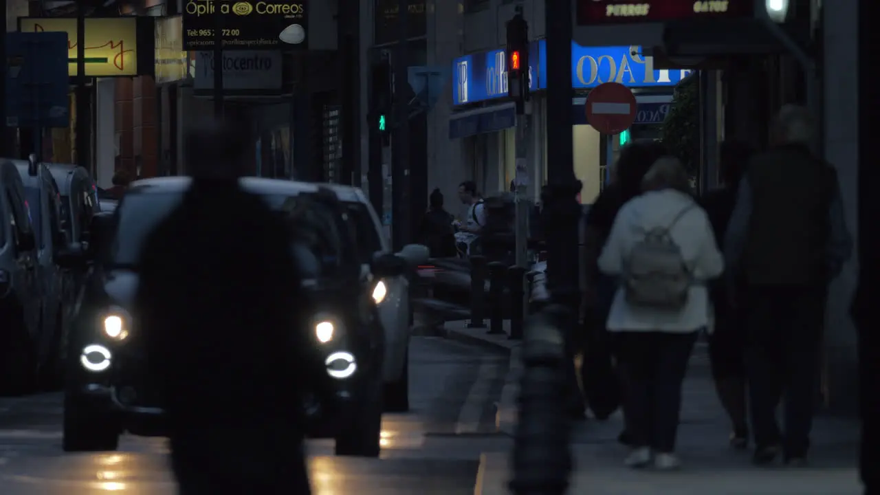 Car and people traffic in night street Spain