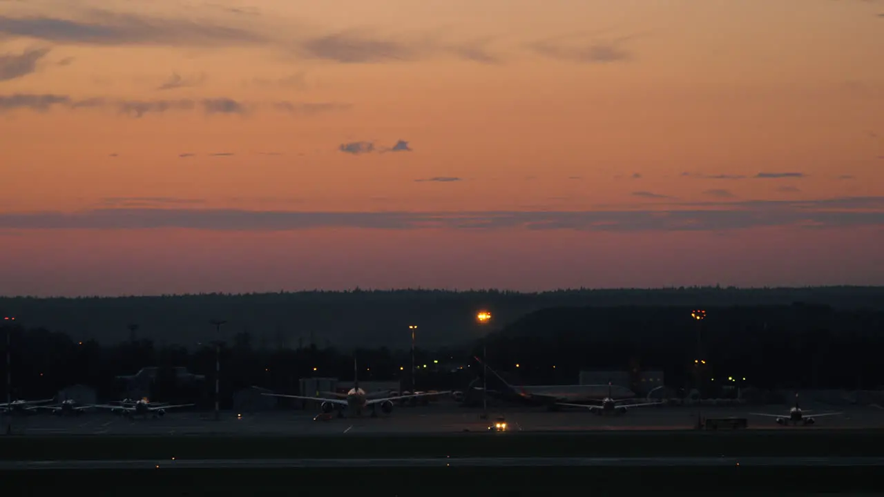 Airport with plane taking off in the dusk