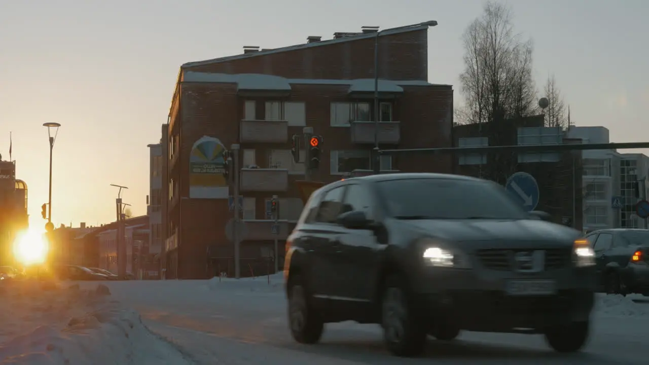 Winter roads with driving cars in Rovaniemi at sunset Finland