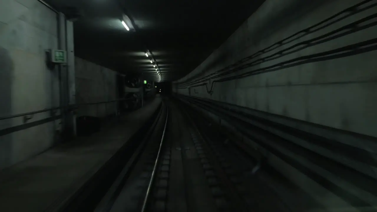 Cabin view of train moving in dark subway tunnel