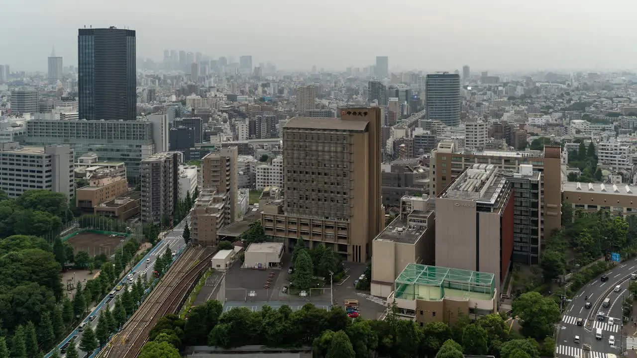 High above timelapse of Tokyo skyline with skyscrapers in distance and traffic push out shot