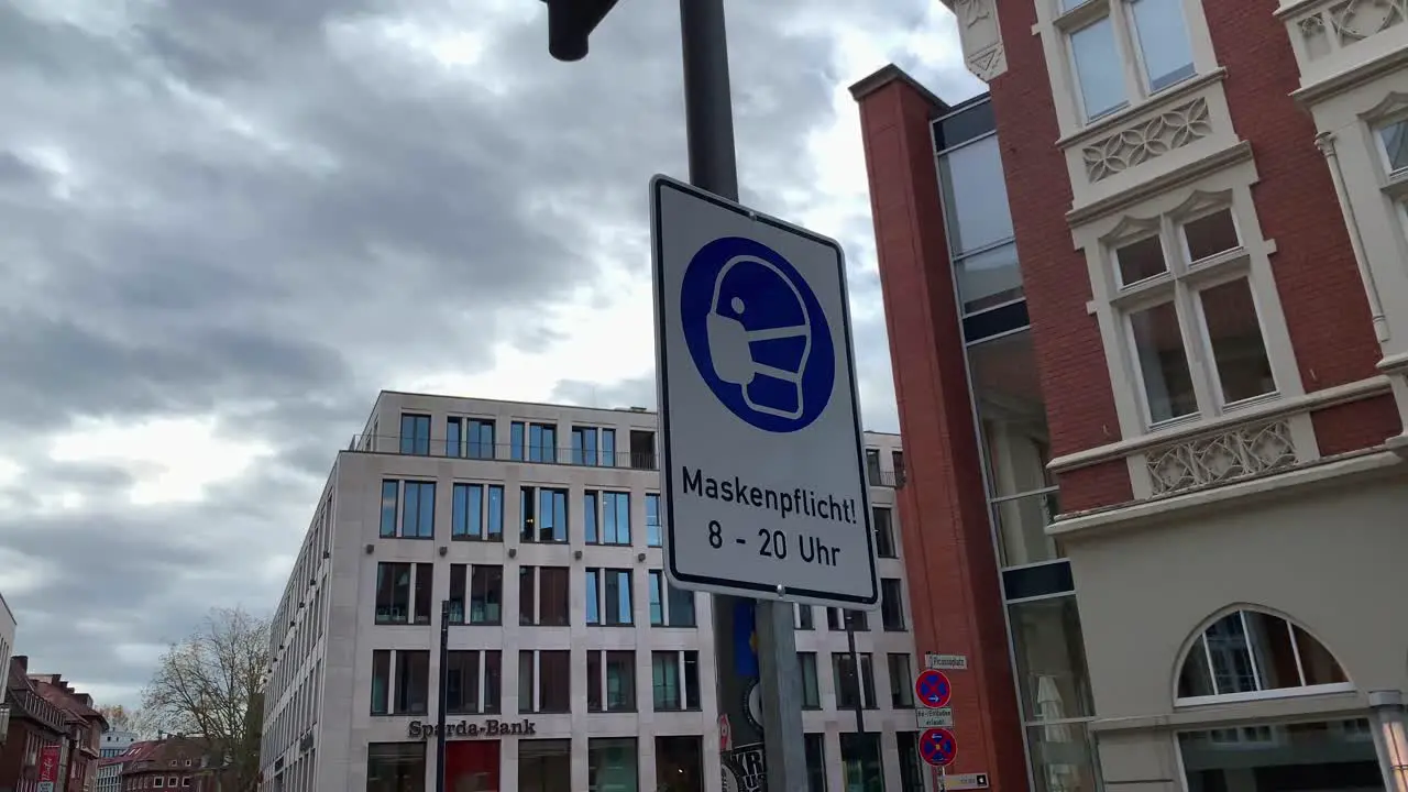 Close up shot of street sign with mask symbol between 8 am and 20 pm in Germany