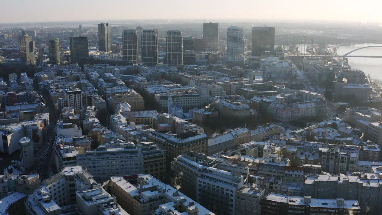 Wide Panorama aerial shot of Bratislava on sunny winter morning covered in snow high rise buildings in background