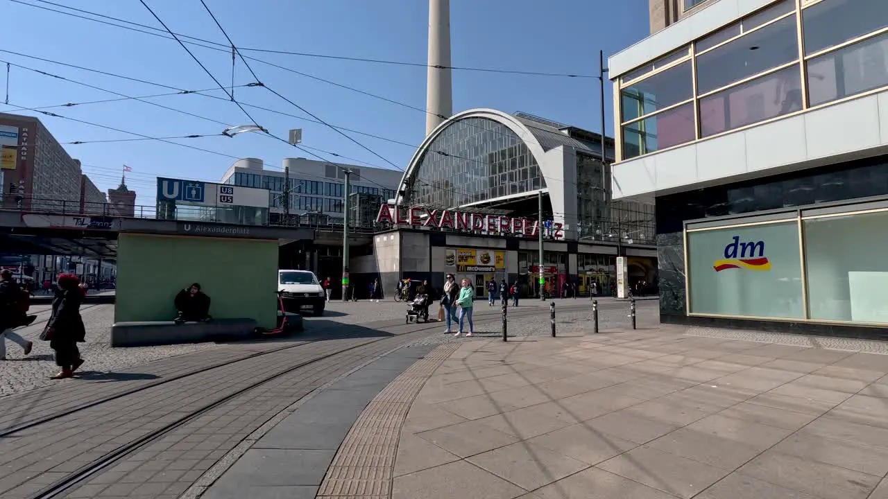 A static shot of people going about their day at the Alexanderplatz a central square on the eastern city centre of Berlin Germany